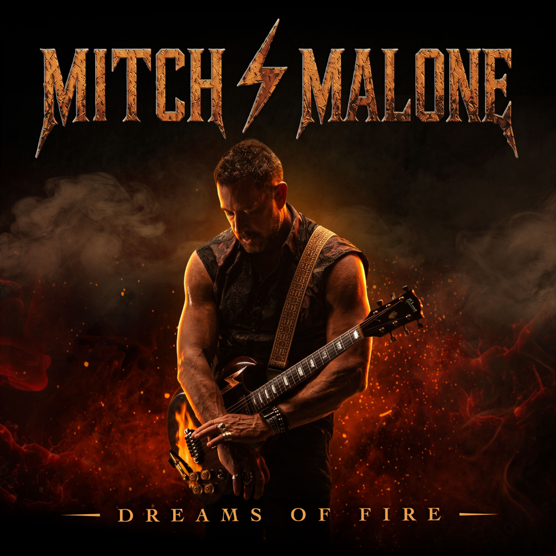 Dreams of Fire album cover: Mitch Malone, head bowed, plays an electric guitar amid smoke and orange embers beneath his name in metallic letters.
